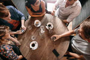 Group of people having coffee to connect about recovery