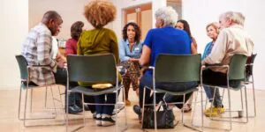 support group meeting with adults sitting in circle