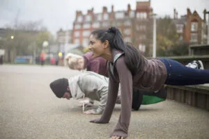 Group of adults exercising in urban environment