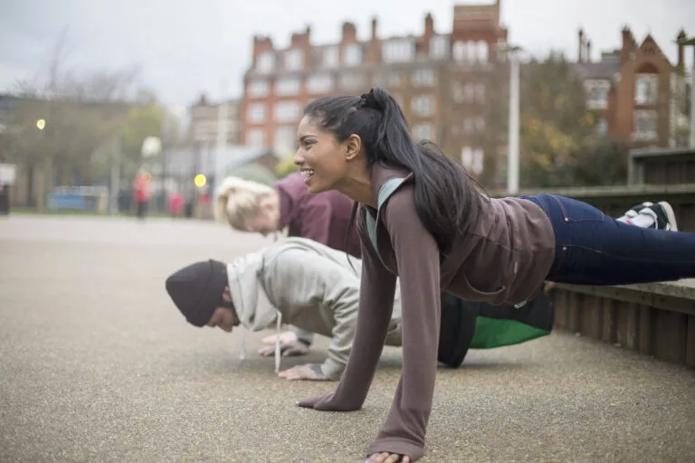 Group of adults exercising in urban environment