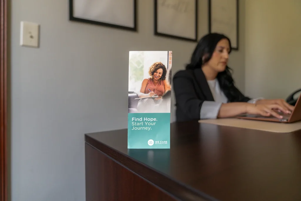 Welcome desk with wellness brochure at We Care Health and Wellness
